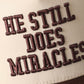 He Still Does Miracles Trucker Hat